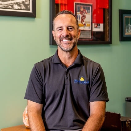 Dr Buckle sitting on desk