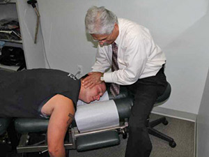 Dr. Auerbach adjusting a patient during a regular visit.