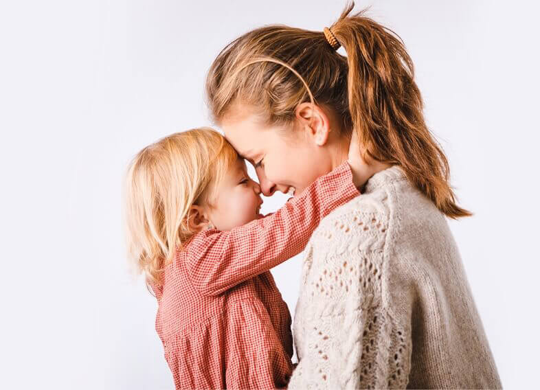 mom and child smiling and touching foreheads