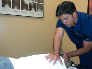 Dr. Anthony Silecchio adjusting a patient.