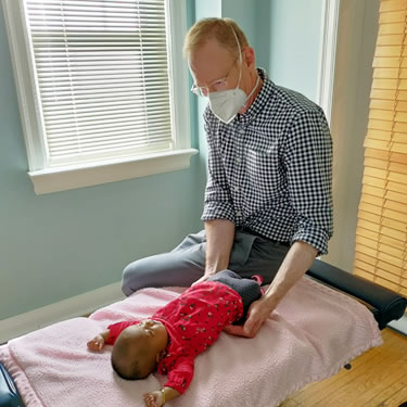 Dr kent adjusting baby