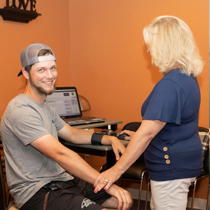 staff testing patient in chair