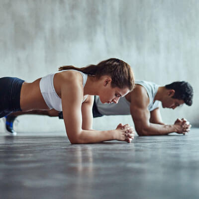 man and woman planking during a workout