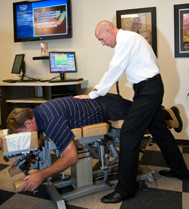 Dr. Escobedo working with a patient. Dr. Escobedo working with a patient.