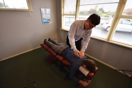 Ian of Hamilton Chiropractic Centre giving a patient a chiropractic adjustment 