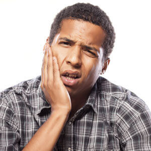 man with hand on jaw pain