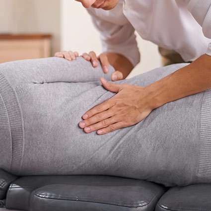 chiropractor adjusting patients back