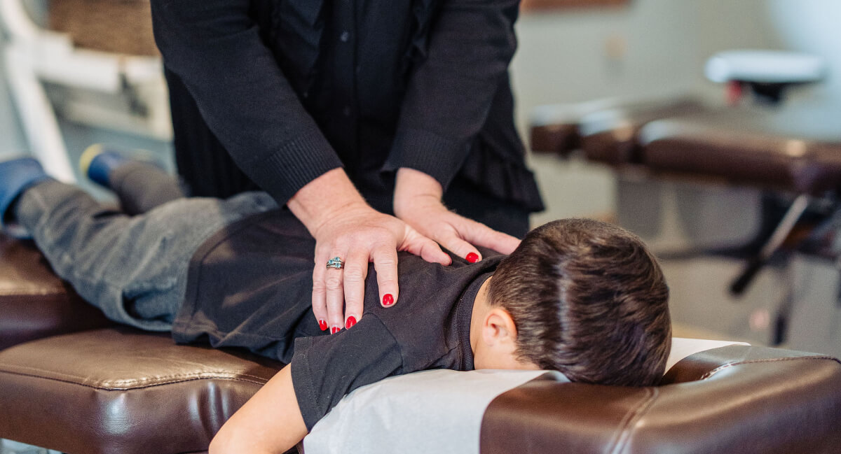 Chiropractor adjusting pediatric patient