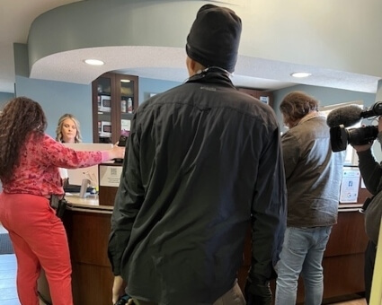 Film crew standing at reception