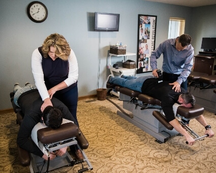 Two patients receiving chiropractic treatment