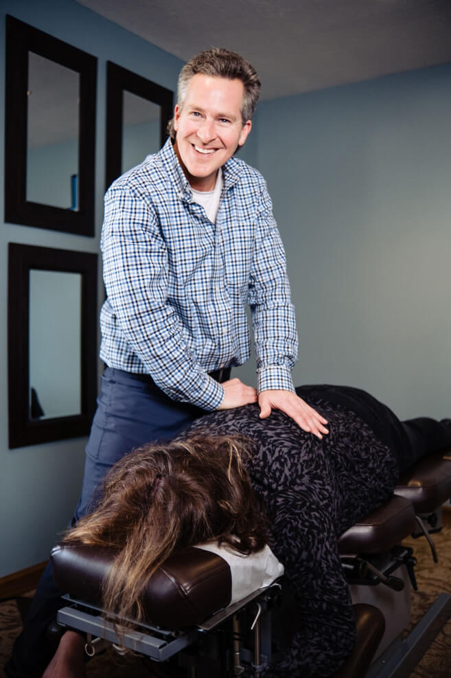 Marysville chiropractor adjusting a female patient's back