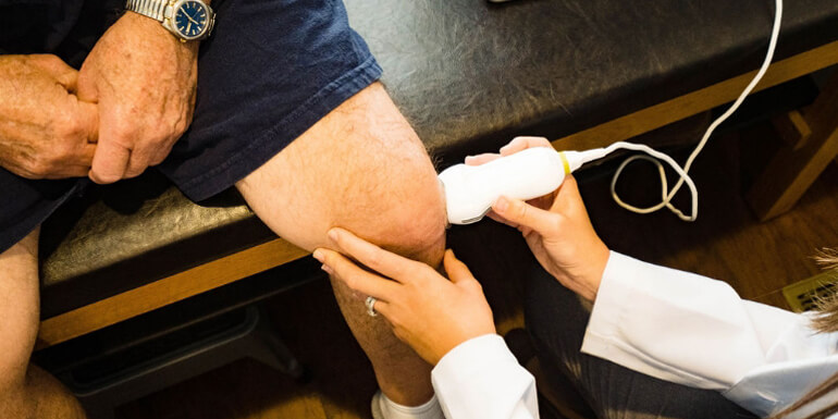 Wave therapy used on patient's knee