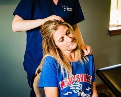 Chiropractor adjusting patient's neck