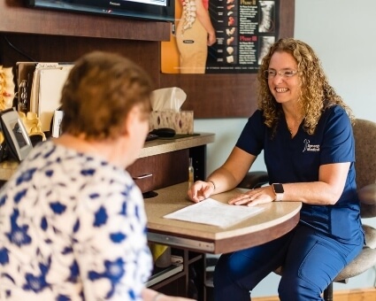 Staff assisting patient with paperwork