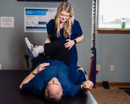 Staff stretching patient's leg