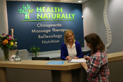 Staff checking in patient at front desk