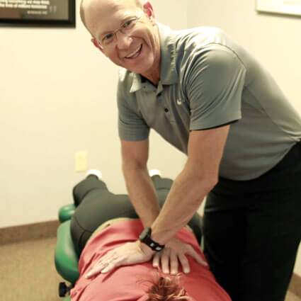 woman having back adjusted