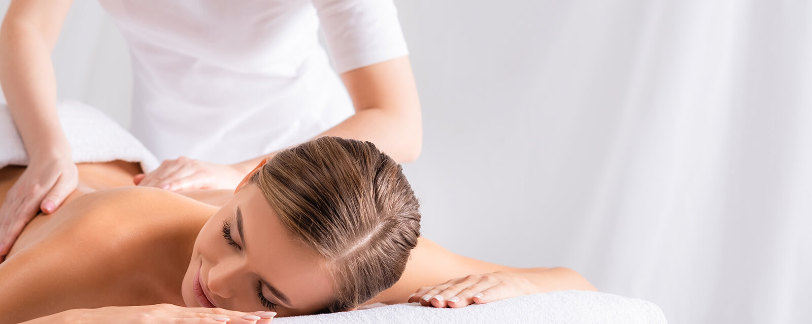 Woman receiving therapeutic back massage