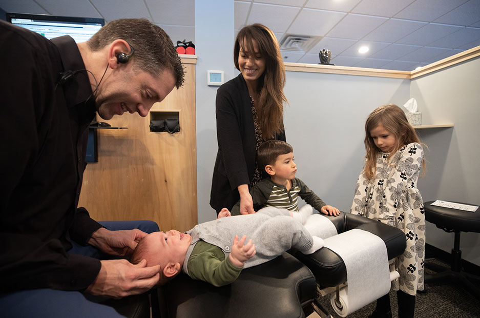 Dr. Mark adjusting baby on table