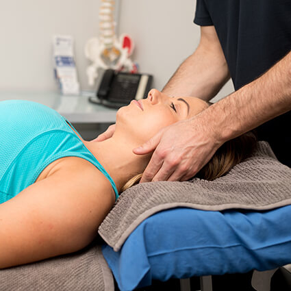Woman getting headache treatment