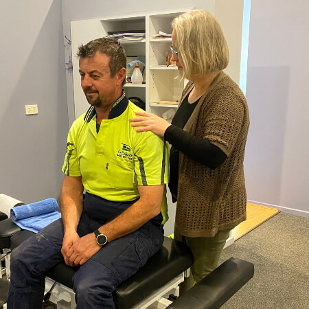 Canberra chiropractor adjusting a patient's back
