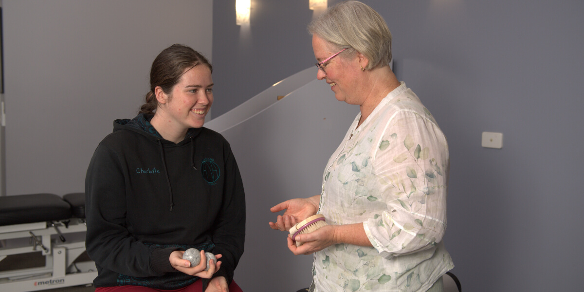 Canberra chiropractor talking to a patient