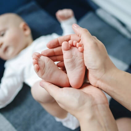 Chiropractor holding baby's feet