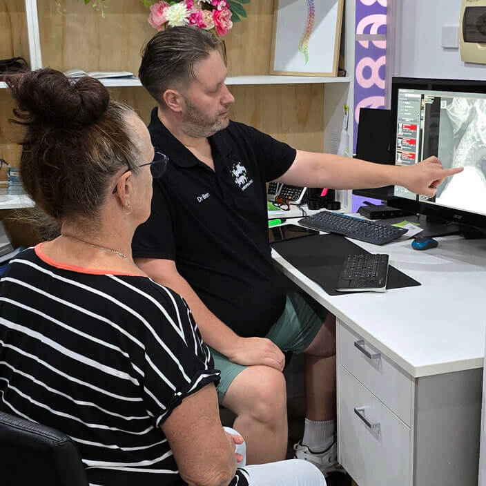 Chiropractor talking to a female patient