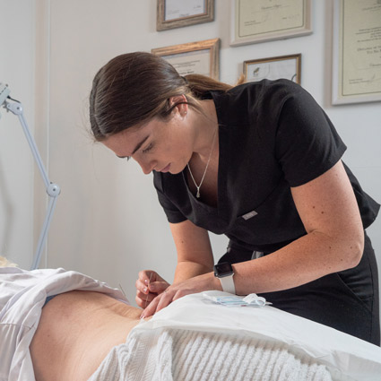 Woman receiving acupuncture therapy