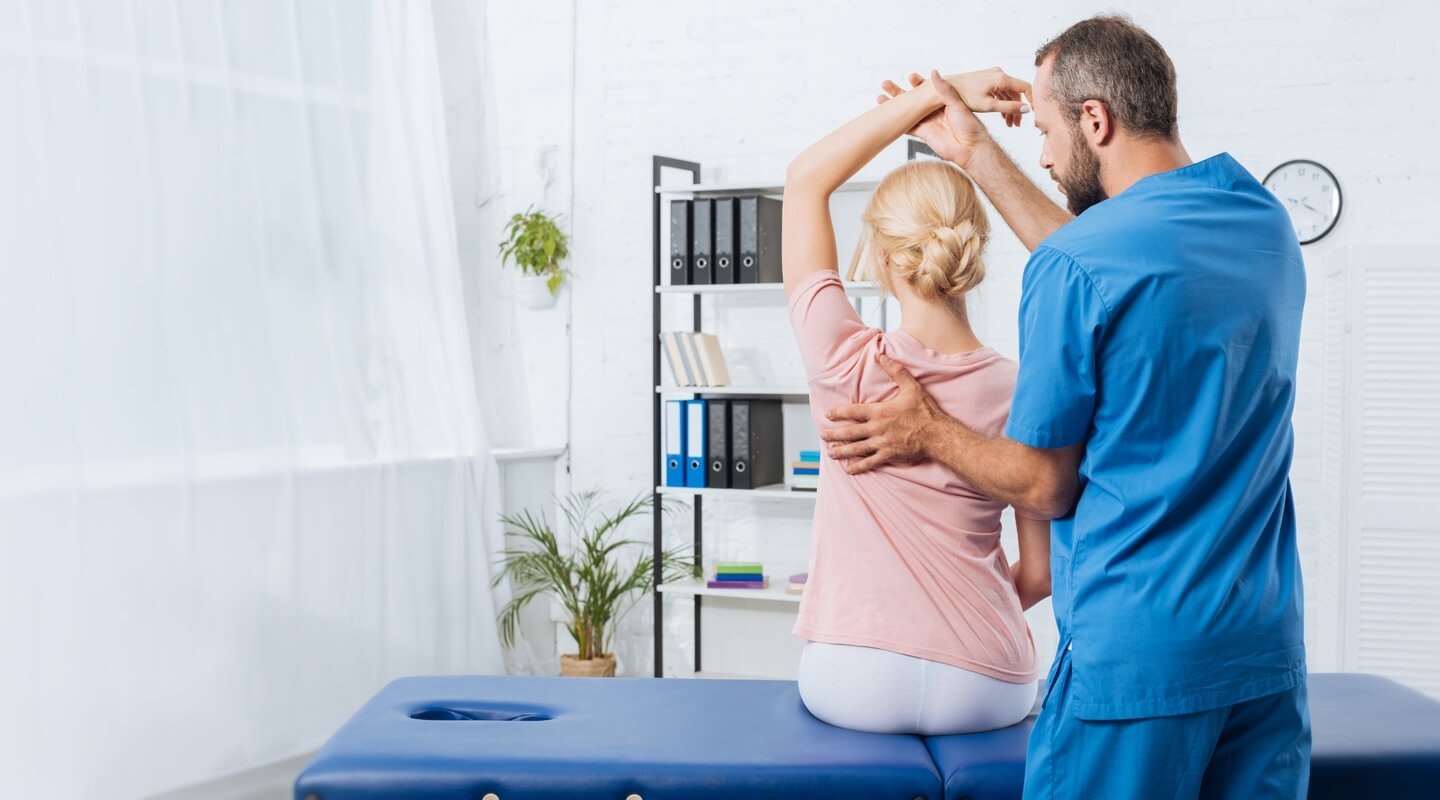 patient with arm up getting adjustment