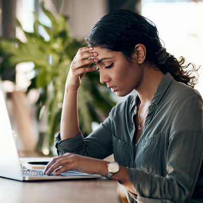woman at computer with headache