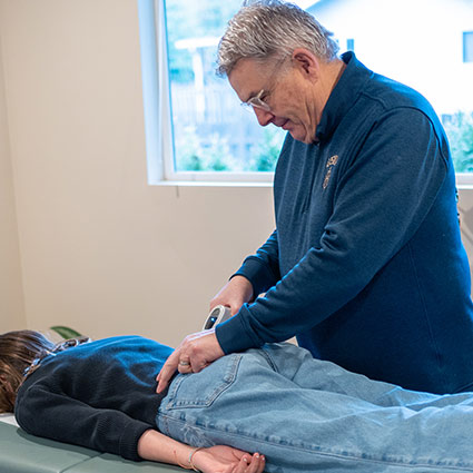 Dr Handly adjusting patient