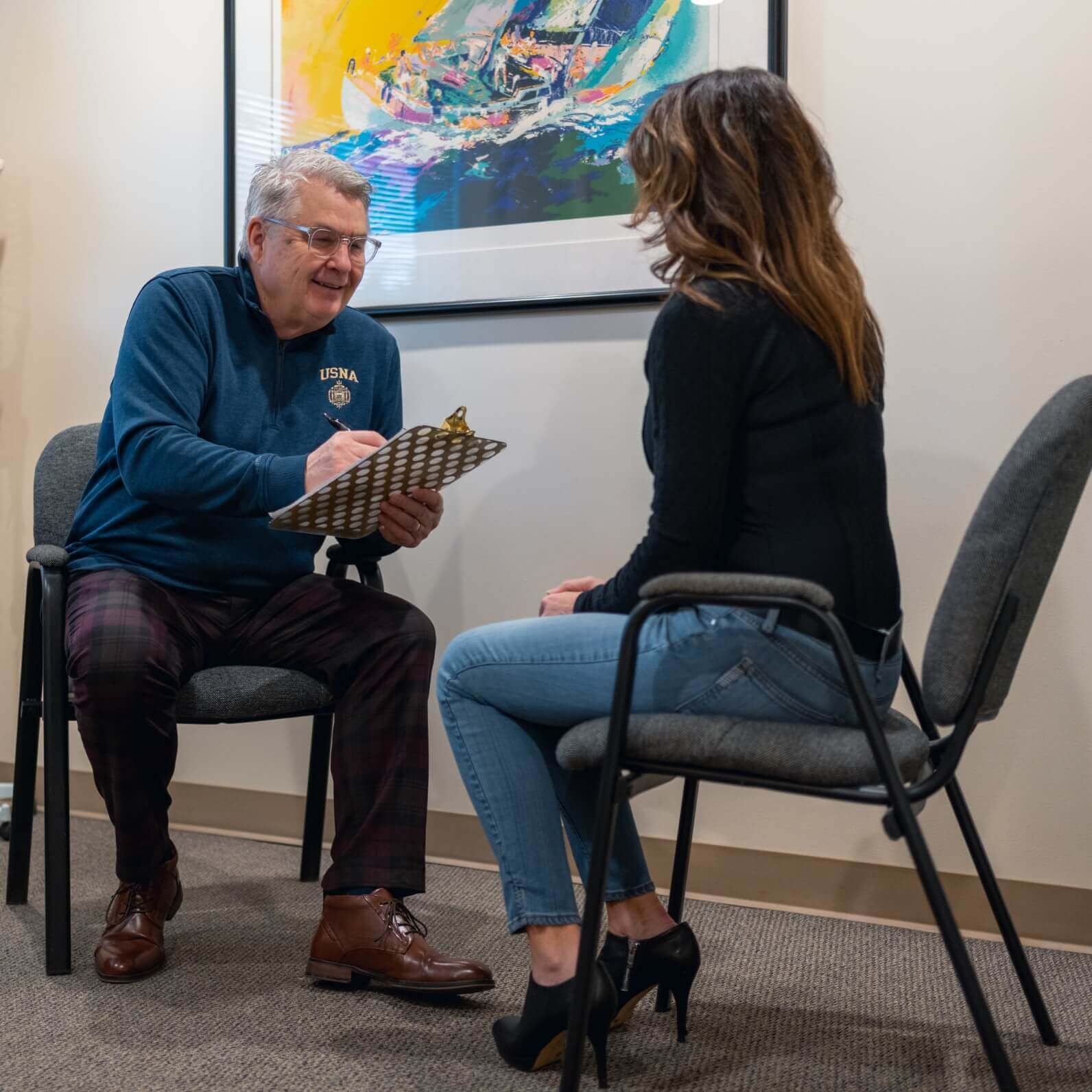 Dr Rod sitting with patient