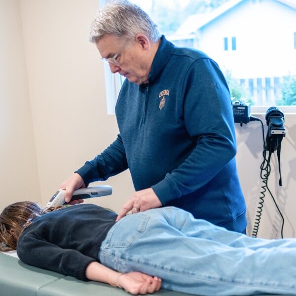 Chiropractor adjusting patient