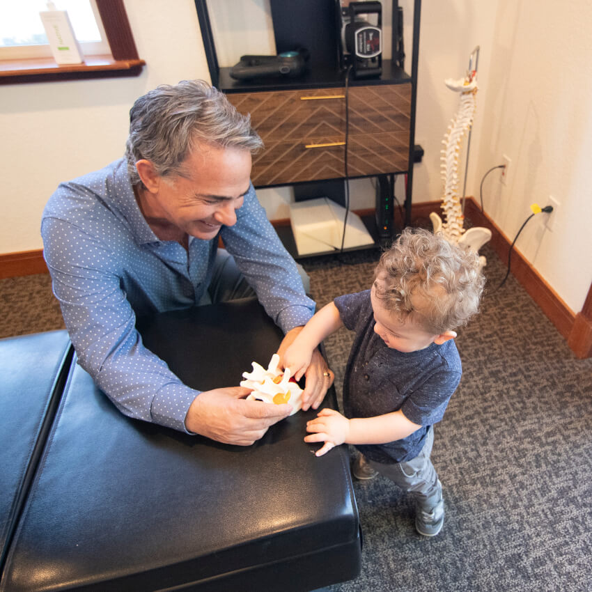 Showing spine model to child