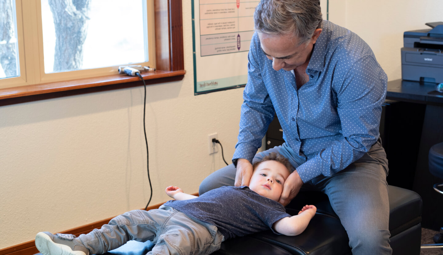 Bend Chiropractor Dr.  Tobey adjusting toddler
