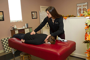 Dr. Sara adjusting a patient