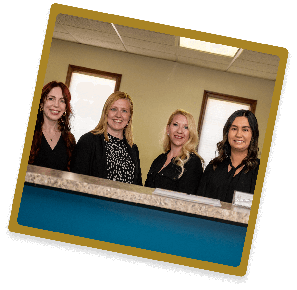 WNY Spinal Solutions staff standing behind reception desk