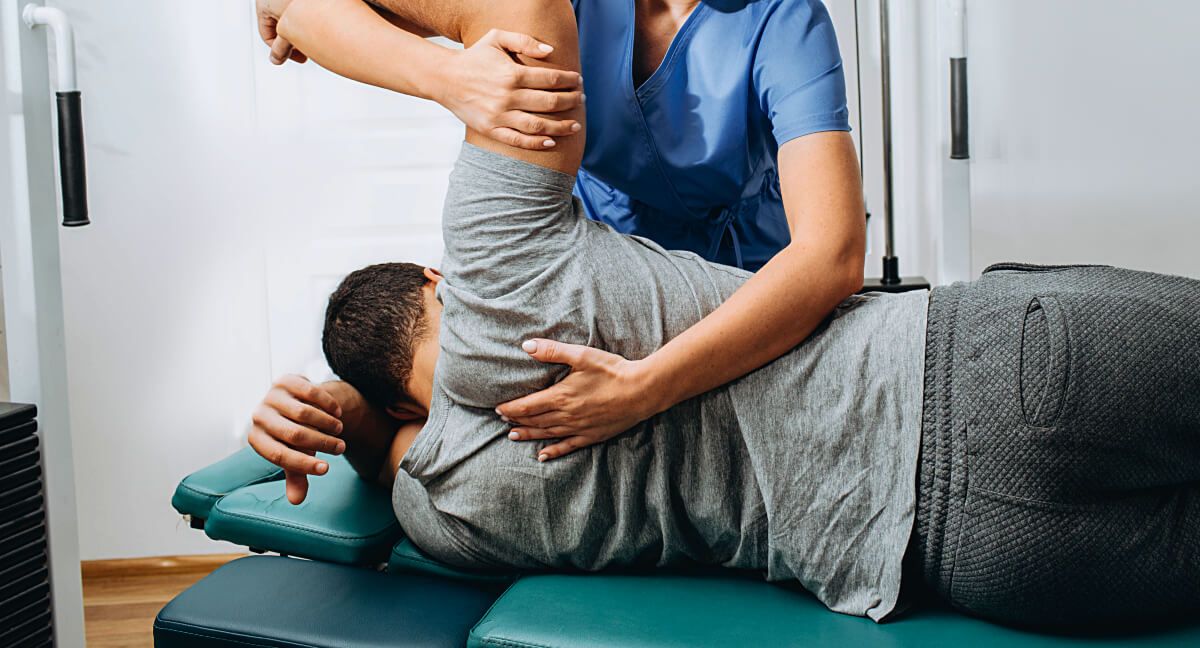 Male patient receiving a chiropractic adjustment