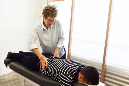 Dr O'Brien adjusting patient's lower back