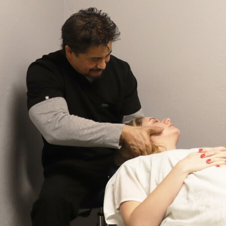 Delano chiropractor adjusting a patient's neck