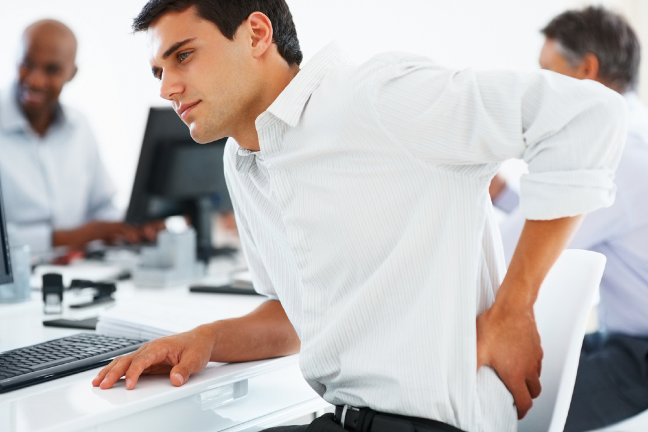 Sitting for extended periods of time can cause lower back pain.