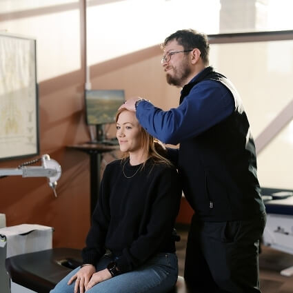 Chiro assisting patient with rehabilitation exercises
