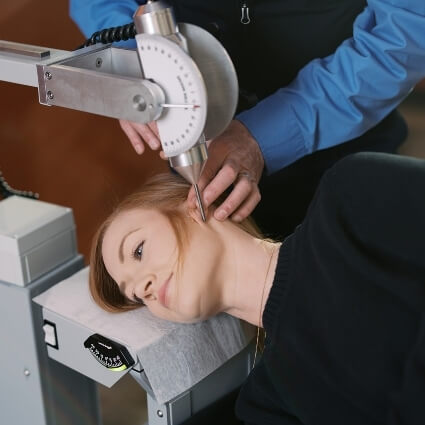 Woman receiving headache treatment