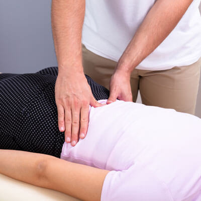 Woman getting low back adjusted