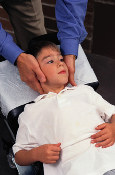 Child receiving a chiropractic adjustment