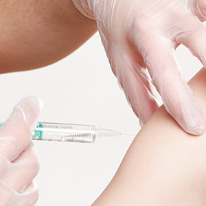 person getting a vaccine in their arm