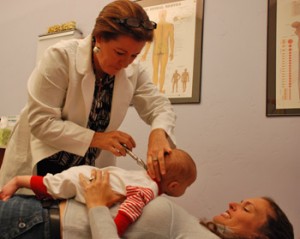 Dr. Janet adjusting one of her youngest patients.