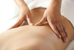 Massage therapists working on patient's back