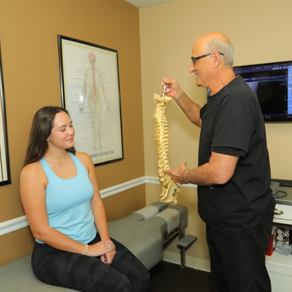 Dr. Richardson educating patient using 3d model of a spine